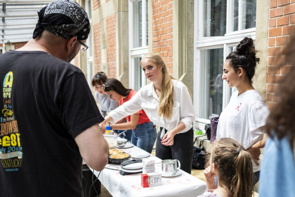 Schüler/innen backen frische Waffeln beim Sommerfest 2019 auf dem Merz Campus